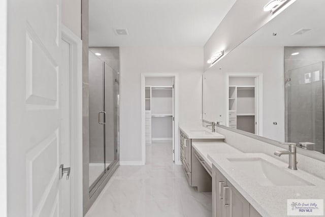 bathroom featuring vanity and an enclosed shower