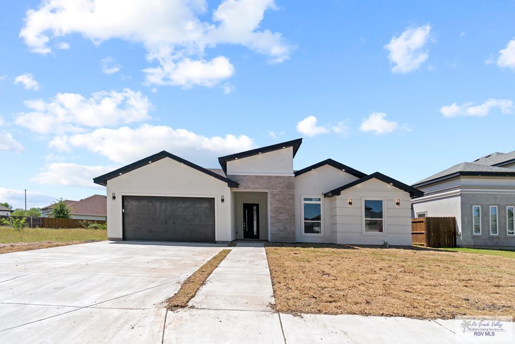 view of front facade with a garage and a front lawn