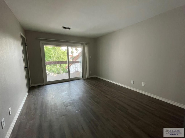 spare room with dark hardwood / wood-style floors