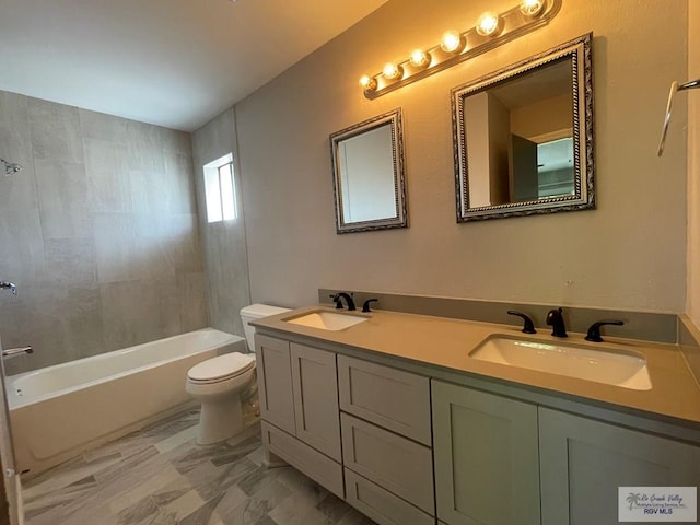 full bathroom featuring vanity, tiled shower / bath combo, and toilet