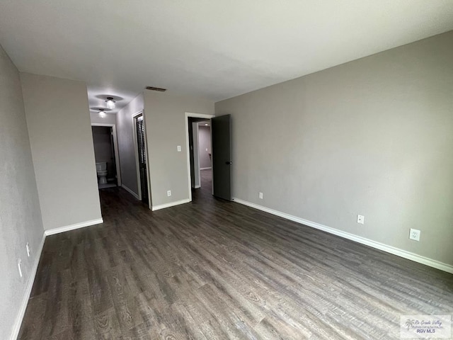 spare room with dark hardwood / wood-style floors