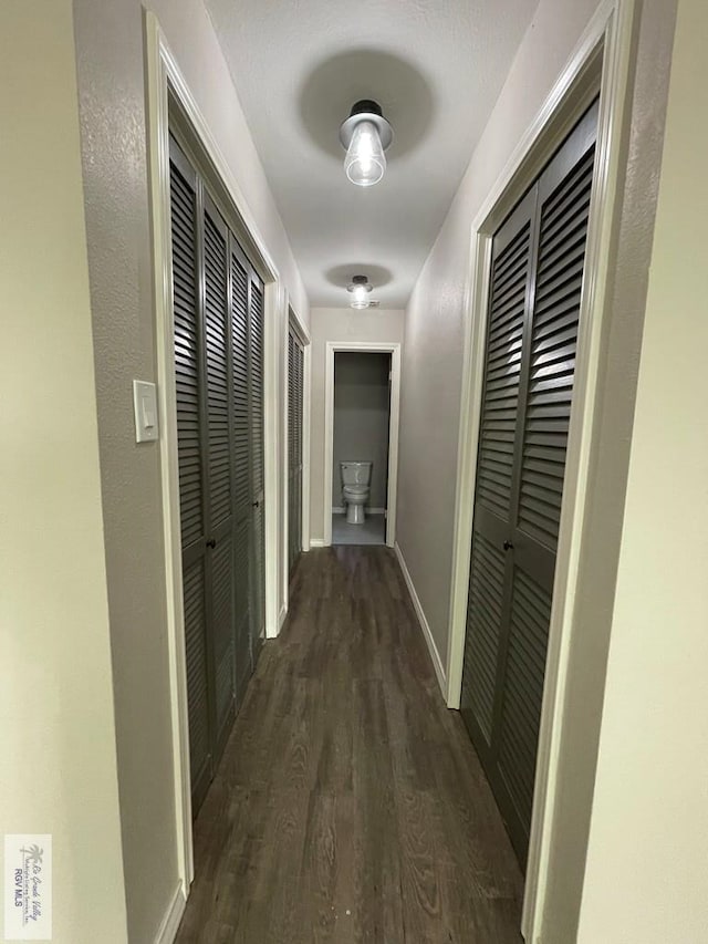 corridor with dark hardwood / wood-style floors