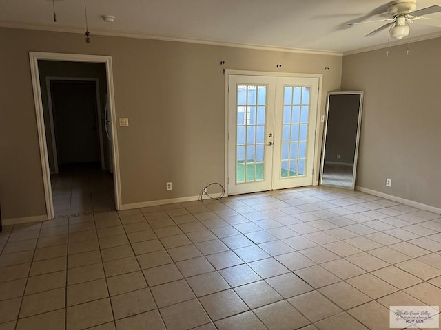 spare room featuring ornamental molding, light tile patterned floors, and french doors