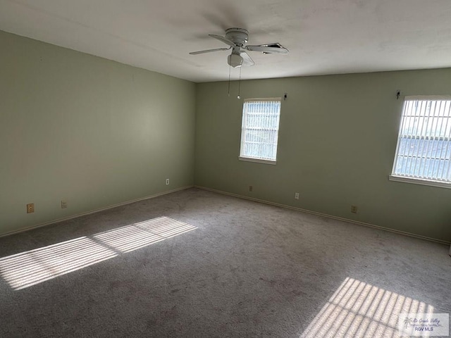 carpeted empty room featuring ceiling fan