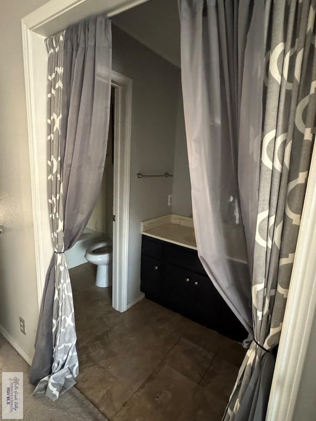 full bathroom featuring vanity, shower / bath combination with curtain, and toilet