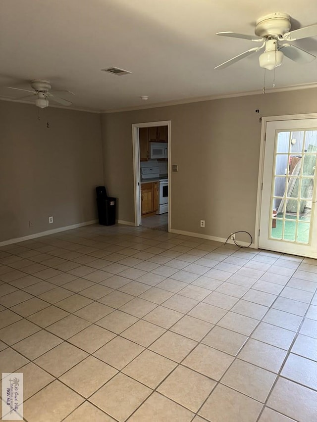 tiled spare room featuring crown molding and ceiling fan