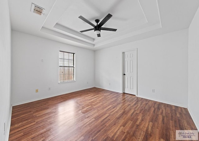 4217 W Ithaca Ave, Mcallen, TX 78501 - unfurnished room featuring a raised ceiling, a ceiling fan, wood finished floors, and baseboards