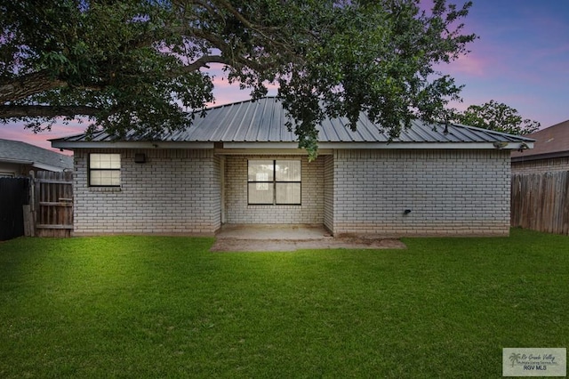 4217 W Ithaca Ave, Mcallen, TX 78501 - rear view of house with brick siding, a patio area, and metal roof