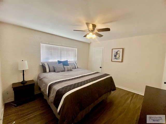 bedroom with a ceiling fan, baseboards, and wood finished floors