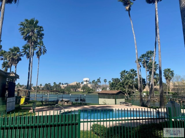 community pool featuring fence and a patio