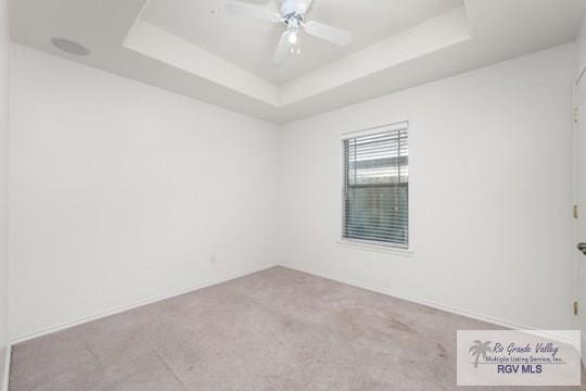 18186 King Palm Dr, Harlingen, TX 78552 - unfurnished room with carpet floors, ceiling fan, and a raised ceiling