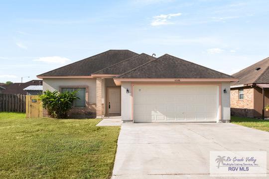 18186 King Palm Dr, Harlingen, TX 78552 - ranch-style home featuring driveway, a garage, and stucco siding