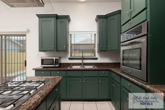 18186 King Palm Dr, Harlingen, TX 78552 - kitchen featuring green cabinetry, stainless steel appliances, a sink, and light tile patterned floors