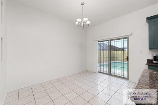 18186 King Palm Dr, Harlingen, TX 78552 - unfurnished dining area featuring a chandelier and light tile patterned flooring
