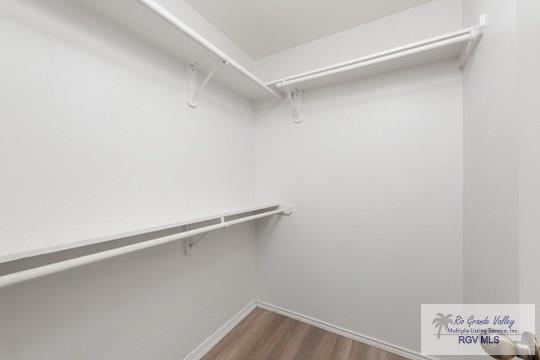 18186 King Palm Dr, Harlingen, TX 78552 - walk in closet with wood finished floors