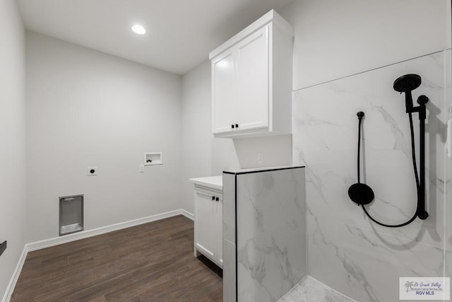 laundry room with cabinets, washer hookup, dark hardwood / wood-style floors, and electric dryer hookup