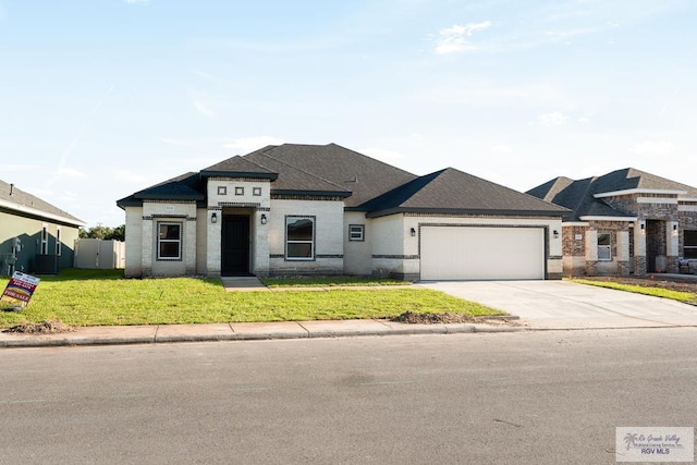 prairie-style home with a garage and a front lawn