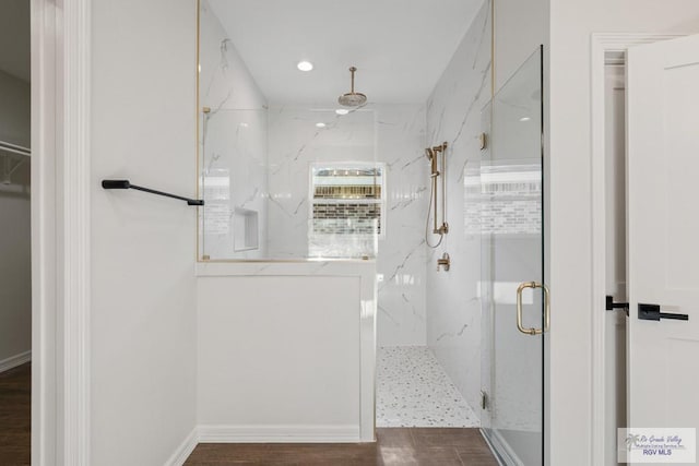 bathroom featuring hardwood / wood-style floors and an enclosed shower