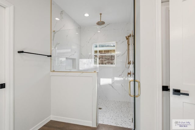 bathroom with hardwood / wood-style flooring and walk in shower