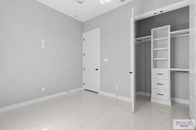 unfurnished bedroom featuring a closet and baseboards