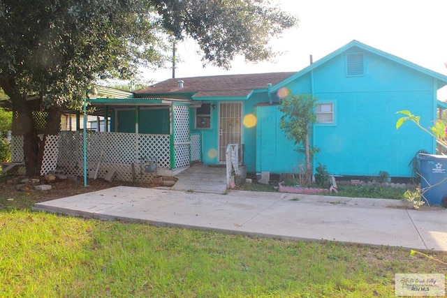 back of property with a patio