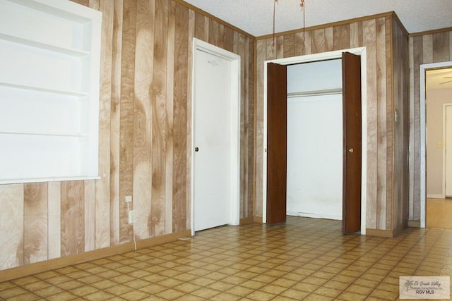 spare room featuring wooden walls