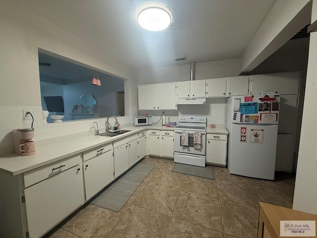 kitchen featuring white appliances, a sink, visible vents, white cabinets, and light countertops