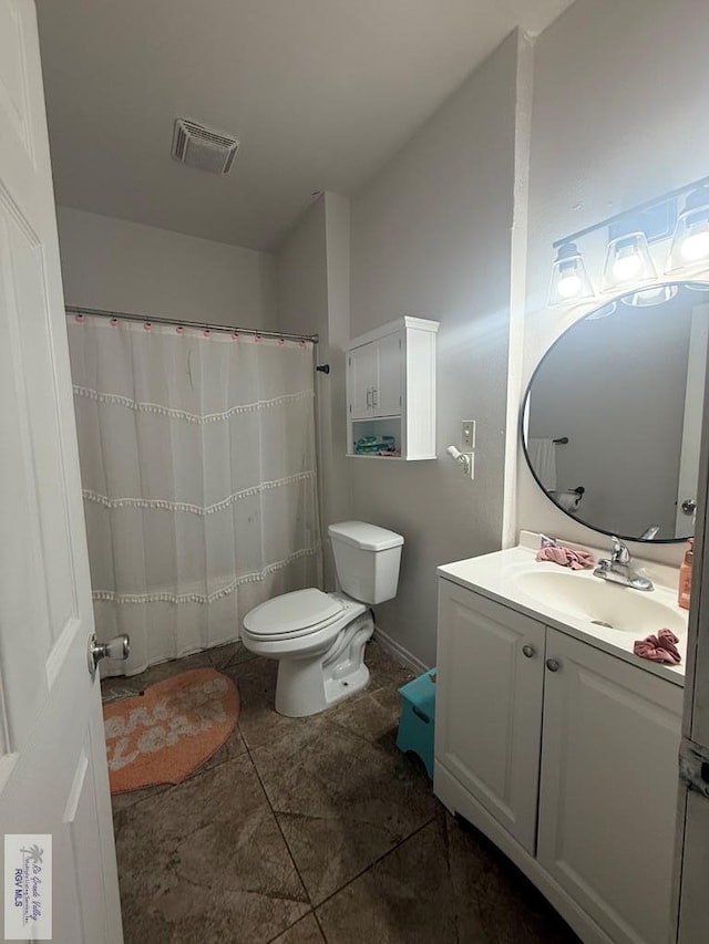 full bath with visible vents, vanity, and toilet