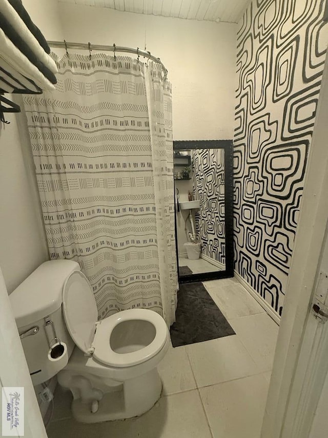 full bathroom featuring tile patterned flooring and toilet