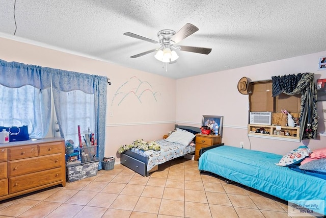 bedroom with a textured ceiling, ceiling fan, cooling unit, and light tile patterned flooring