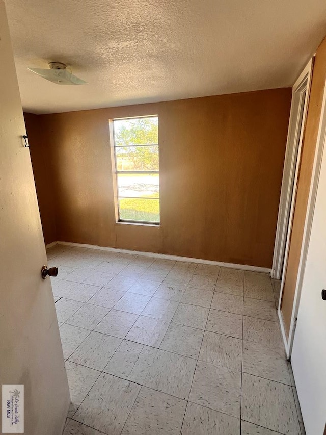 spare room with a textured ceiling