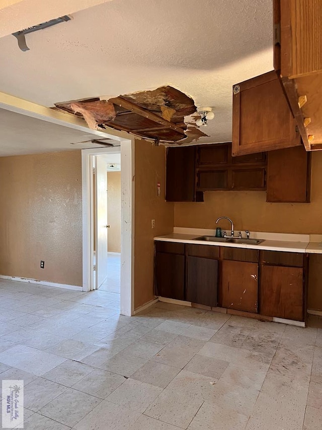 kitchen with a textured ceiling and sink