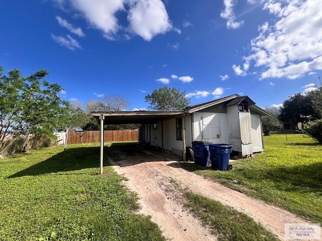 exterior space featuring a carport and a front yard