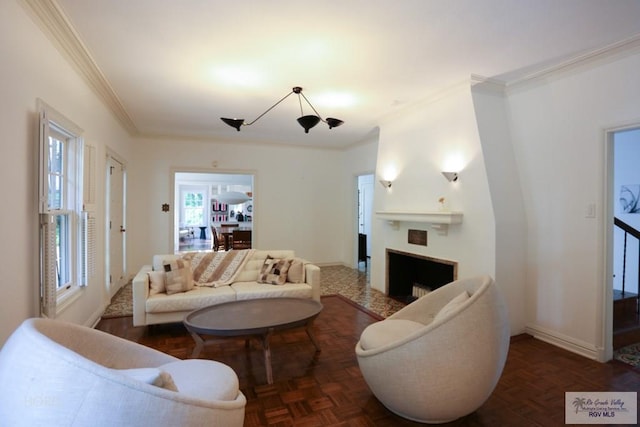 living room featuring plenty of natural light, dark parquet floors, and ornamental molding