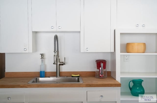 kitchen with white cabinetry and sink