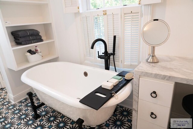 bathroom featuring vanity and a bath