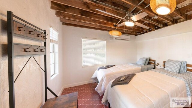 bedroom featuring beamed ceiling, ceiling fan, dark tile patterned floors, and a wall mounted AC