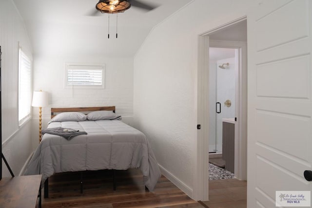 bedroom featuring hardwood / wood-style floors, vaulted ceiling, and ceiling fan