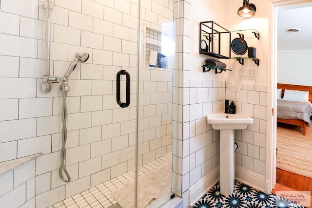 bathroom featuring sink, tile patterned flooring, and walk in shower