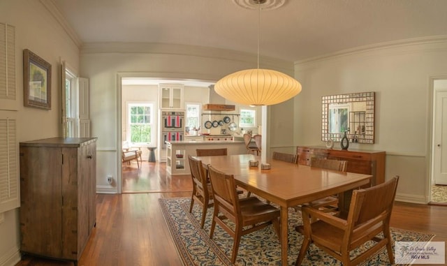 dining area featuring crown molding and wood-type flooring