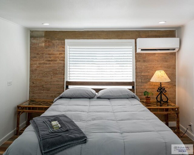 bedroom with dark wood-type flooring and a wall unit AC