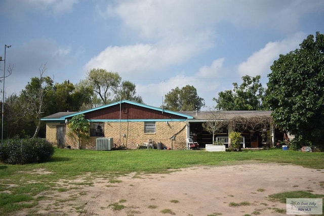 exterior space with cooling unit and a lawn