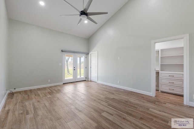 empty room with light wood-style floors, baseboards, a ceiling fan, and french doors