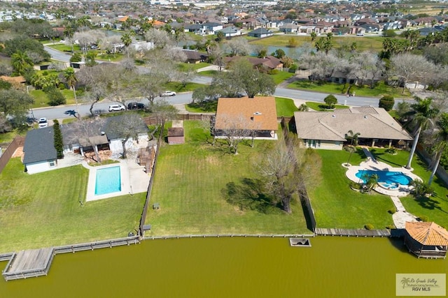 drone / aerial view featuring a residential view and a water view