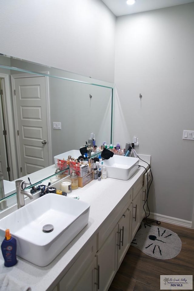 4080 Westland Dr, Brownsville, TX 78521 - bathroom featuring double vanity, wood finished floors, and recessed lighting