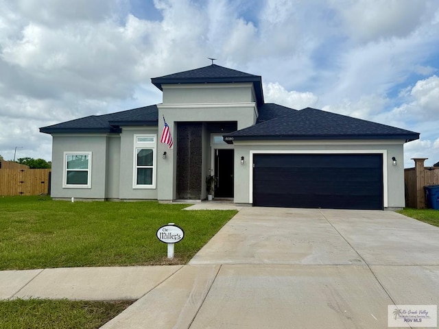 4080 Westland Dr, Brownsville, TX 78521 - prairie-style house featuring an attached garage, concrete driveway, stucco siding, and roof with shingles