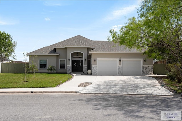 view of front of property featuring a front yard and a garage