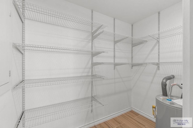 1000 E Palm Valley Dr, Palm Valley, TX 78552 - spacious closet featuring wood finished floors and water heater