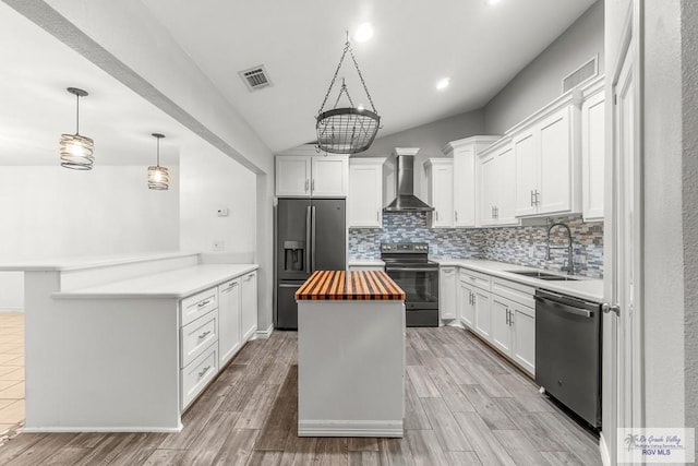 1000 E Palm Valley Dr, Palm Valley, TX 78552 - kitchen with stainless steel appliances, wall chimney exhaust hood, wooden counters, decorative backsplash, and a kitchen island