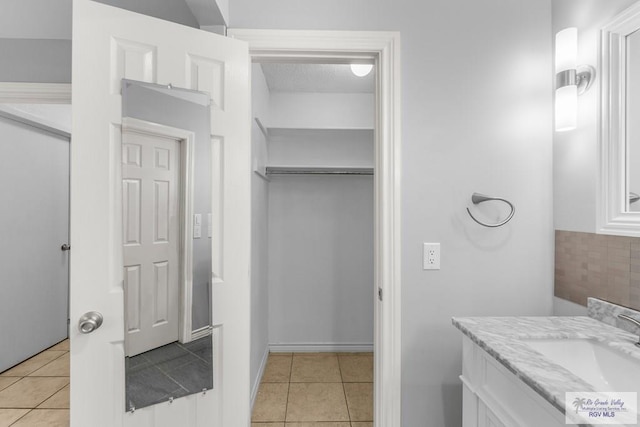 1000 E Palm Valley Dr, Palm Valley, TX 78552 - bathroom with vanity, tile patterned floors, and backsplash